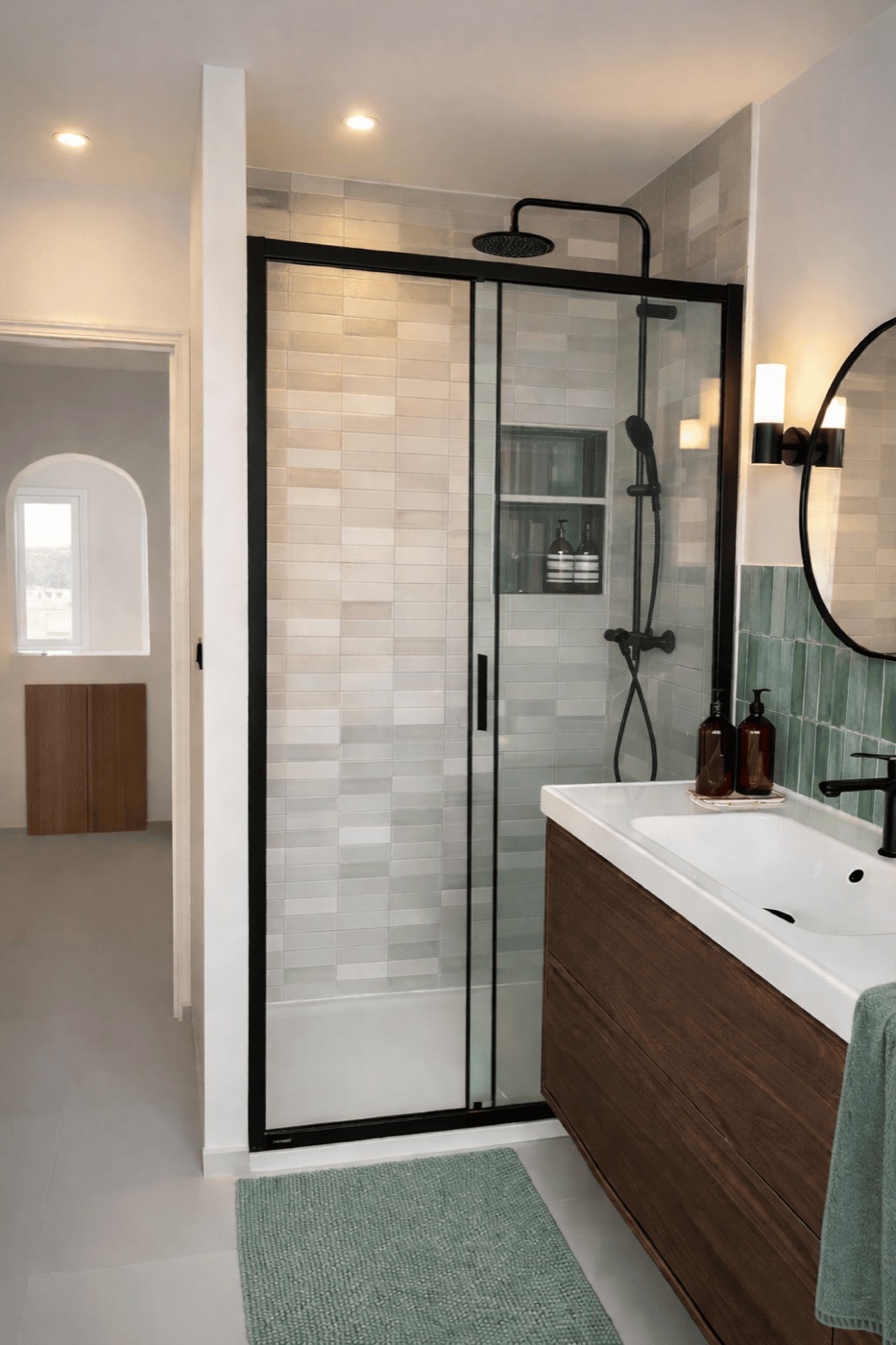 Walk-in shower with green glazed tiles, black frame and a dark wood vanity, Marseille 7th arrondissement renovation