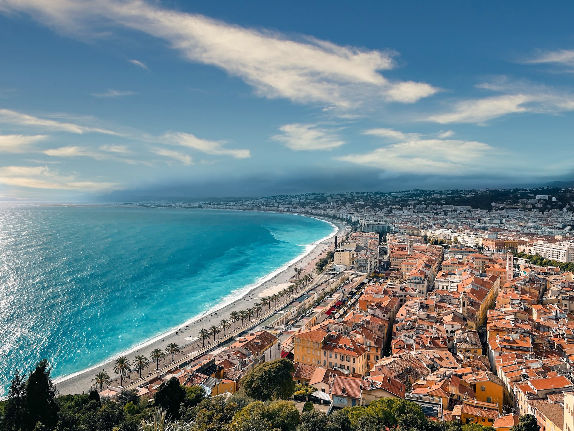The Baie des Anges seen from the Colline du Chateau, with the Promenade des Anglais, the pebble beach and the terracotta roofs of Vieux Nice