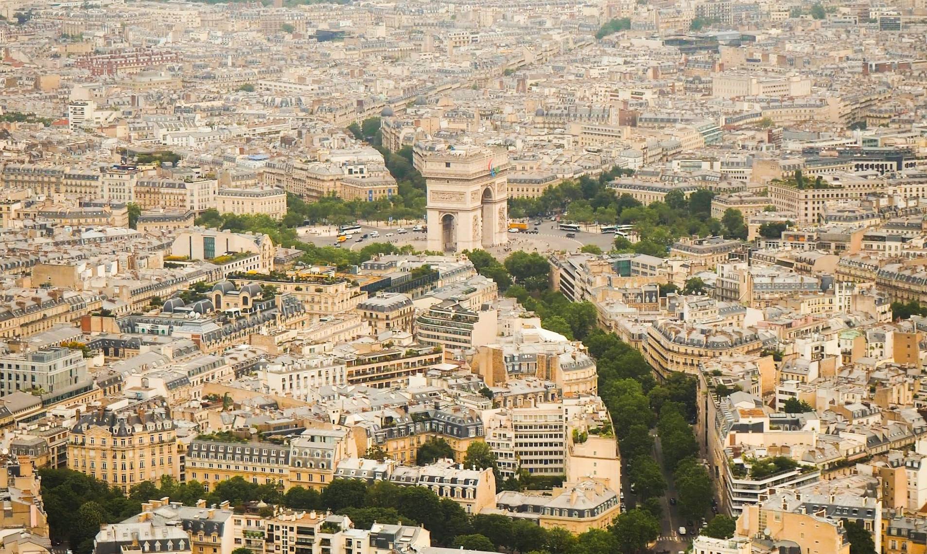 Aerial view of Paris with the Arc de Triomphe and the Haussmannian rooftops of the 8th and 16th arrondissements